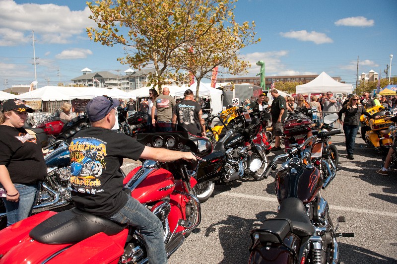 event attendees visiting motorcycles and vendor tents in OC Convention Center parking lot