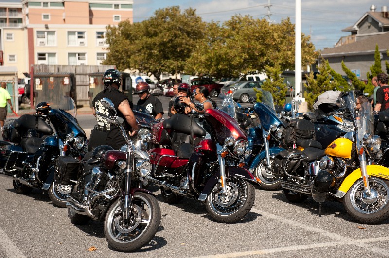 multiple motorcyles parked in parking lot